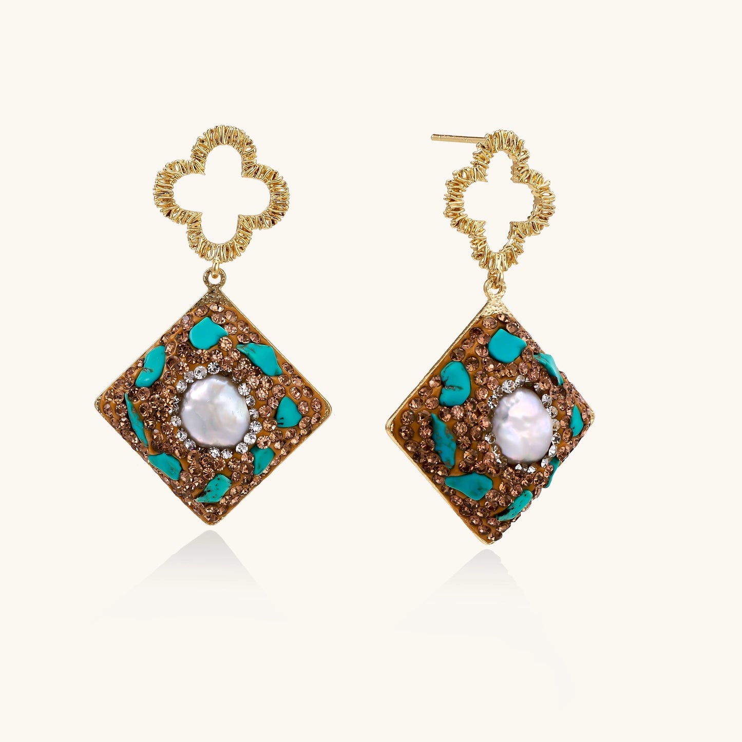 Gold quatrefoil stud earrings with ornate square pendants featuring turquoise stones and freshwater pearls