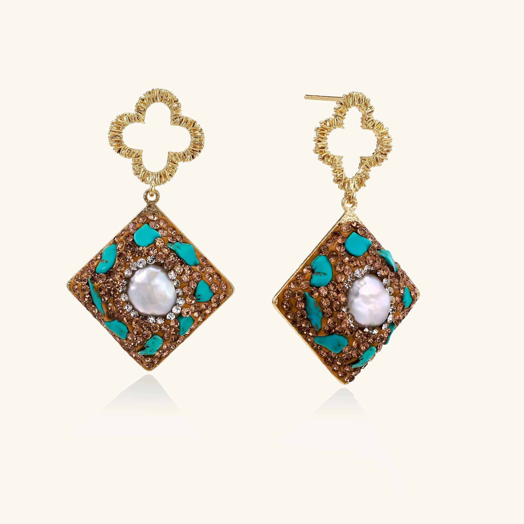 Gold quatrefoil stud earrings with ornate square pendants featuring turquoise stones and freshwater pearls