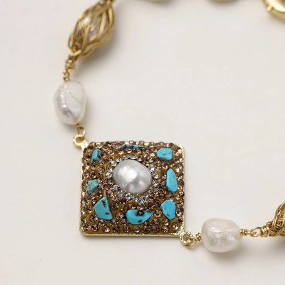 Ornate gold-plated bracelet with square turquoise and crystal centerpiece, freshwater pearls, and decorative chain links