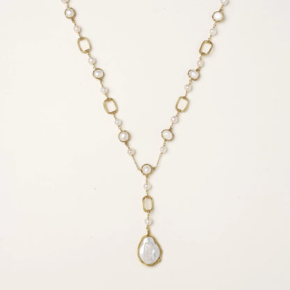 Y-shaped gold-plated necklace with freshwater pearls and geometric elements, featuring a baroque pearl pendant drop