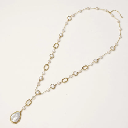 Y-shaped gold-plated necklace with freshwater pearls and geometric elements, featuring a baroque pearl pendant drop