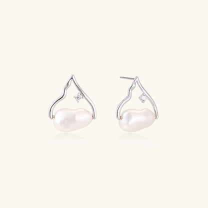 Sterling silver teardrop-shaped stud earrings with white freshwater pearls nestled in elegant flame-like frames