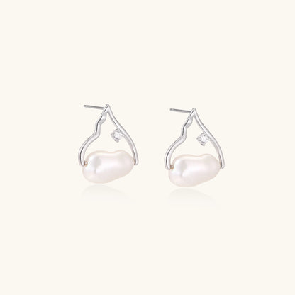 Sterling silver teardrop-shaped stud earrings with white freshwater pearls nestled in elegant flame-like frames