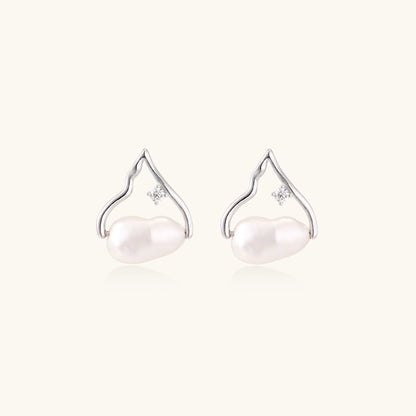 Sterling silver teardrop-shaped stud earrings with white freshwater pearls nestled in elegant flame-like frames