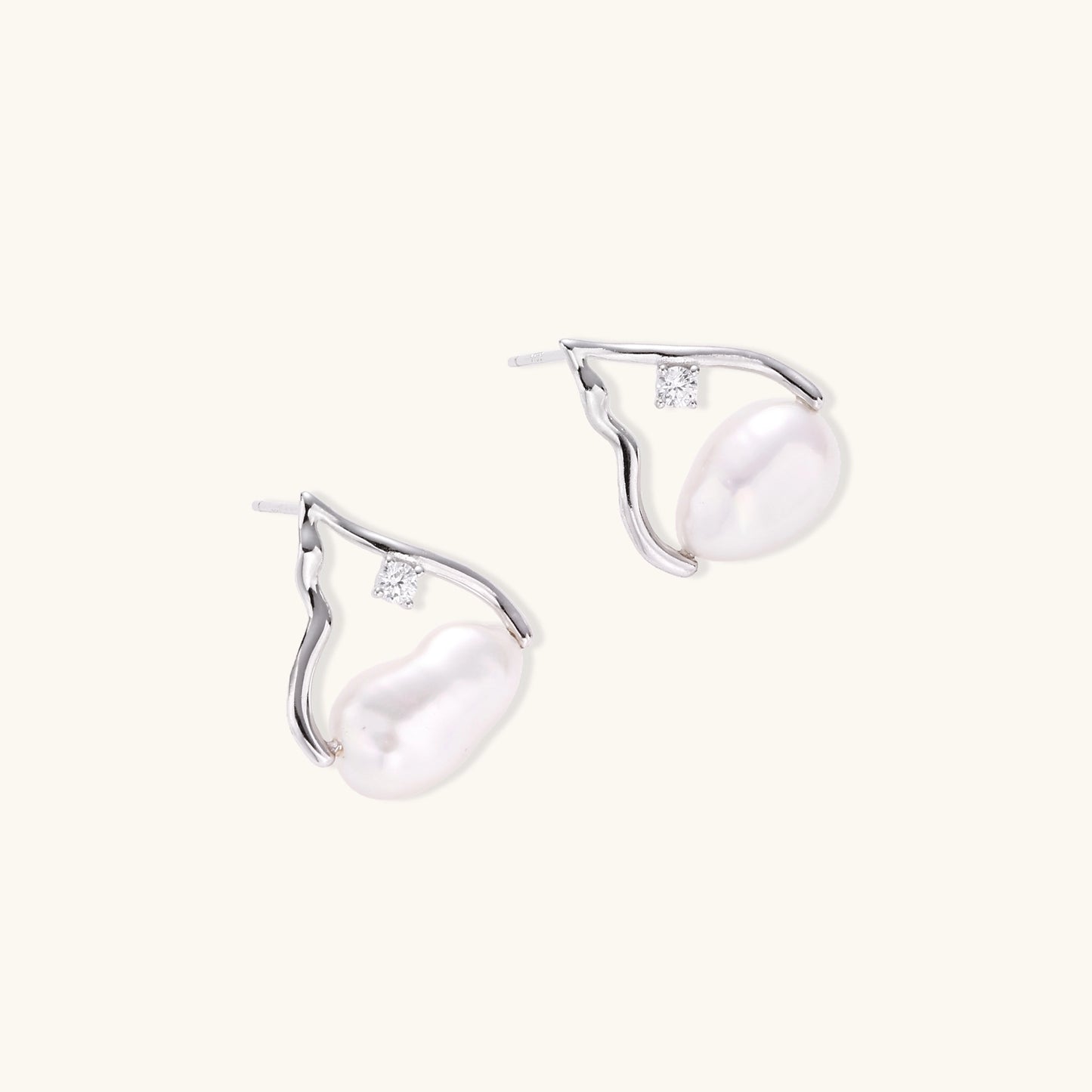 Sterling silver teardrop-shaped stud earrings with white freshwater pearls nestled in elegant flame-like frames