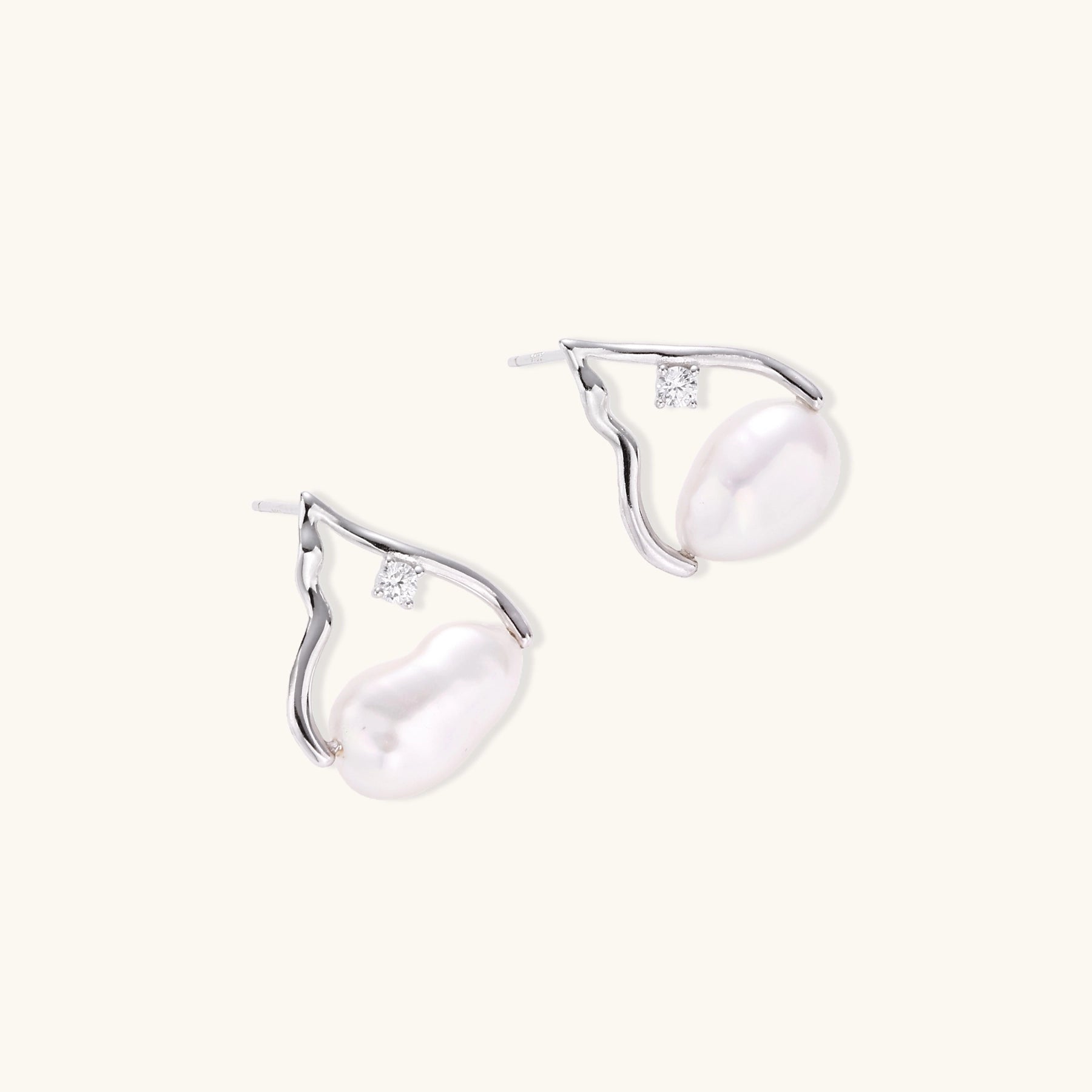 Sterling silver teardrop-shaped stud earrings with white freshwater pearls nestled in elegant flame-like frames
