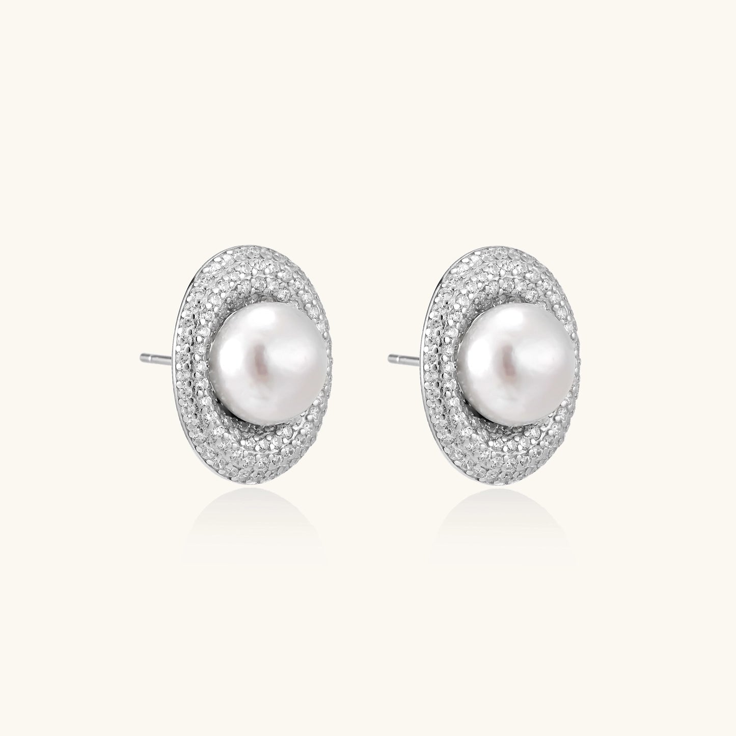 Sterling silver stud earrings with freshwater pearls surrounded by sparkling pavé crystals on white background.
