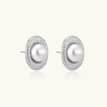 Sterling silver stud earrings with freshwater pearls surrounded by sparkling pavé crystals on white background.