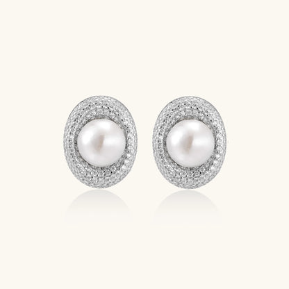 Sterling silver stud earrings with freshwater pearls surrounded by sparkling pavé crystals on white background.