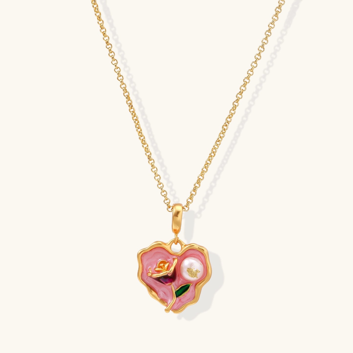 Gold-plated heart pendant necklace with pink enamel rose design and freshwater pearl on adjustable chain