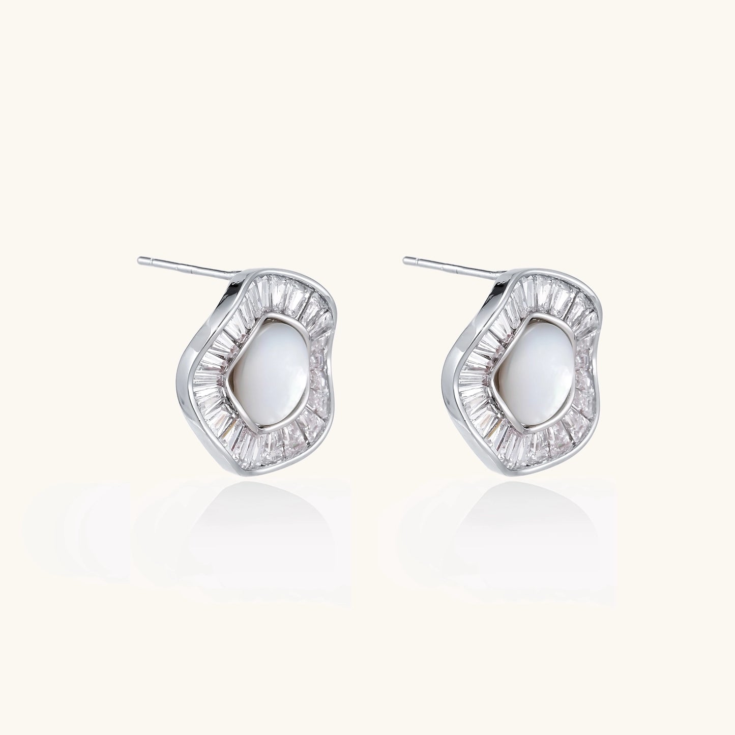 Gold-plated stud earrings with central freshwater pearl surrounded by baguette crystals in radial pattern
